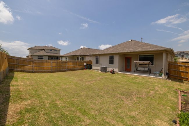 Back of house featuring central air condition unit, stucco siding, and a patio | Image 23