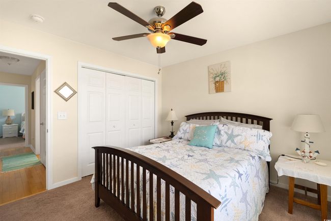 Bedroom featuring carpet floors, a closet, baseboards, and ceiling fan | Image 15