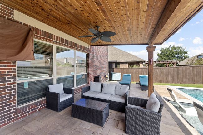 View of patio with a ceiling fan, outdoor lounge area, a fenced in pool, and fence | Image 30