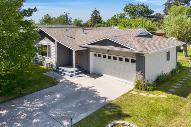 Ranch-style house featuring driveway, a garage, and roof with shingles | Image 43