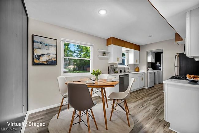 Dining space with washer and dryer and light wood-style floors | Image 22