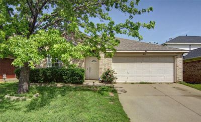 View of front of property with a garage and a front yard | Image 1