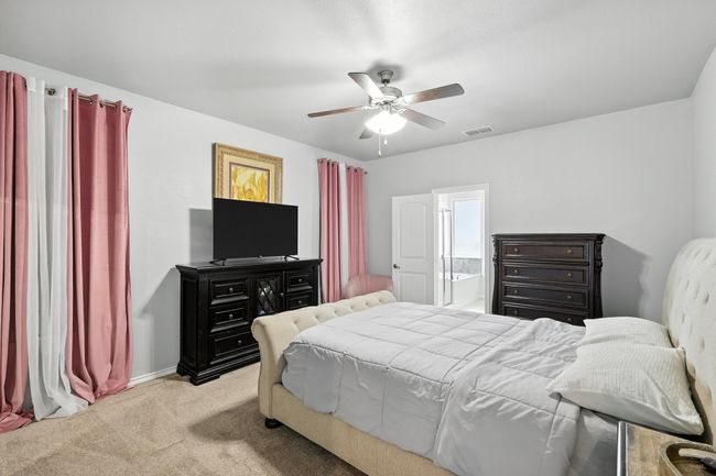 Bedroom with carpet floors and a ceiling fan | Image 10