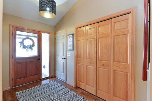 Entryway with new lighting and showing the way to the garage | Image 8