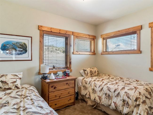 Bedroom with multiple windows and carpet floors | Image 26