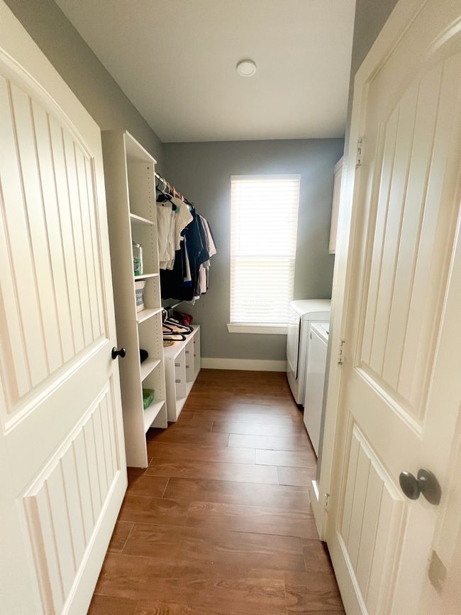 Laundry area with wood-type flooring and washer and clothes dryer | Image 17