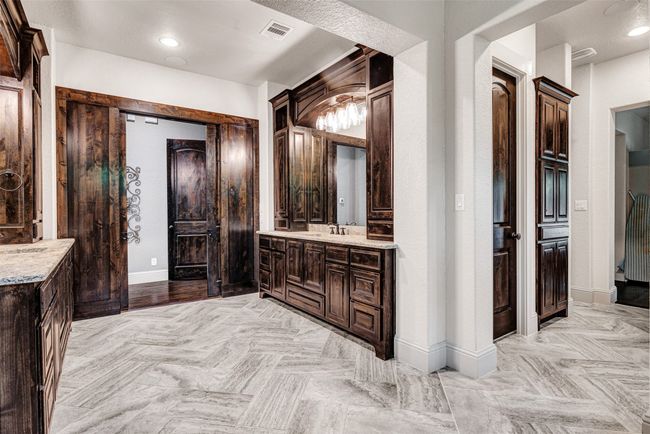The bathroom has pocket doors to the bedroom, plenty of storage, custom walk-in closet with built-in vanity area and dresser, plus a Steambath system in the shower. You may decide just to live in this room! | Image 25