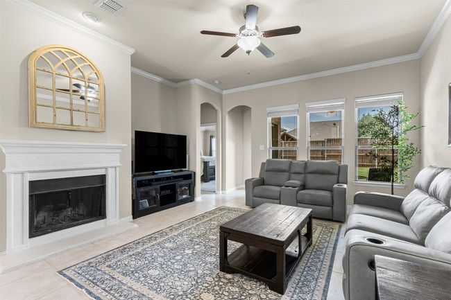 living room with great natural light and a fireplace | Image 7