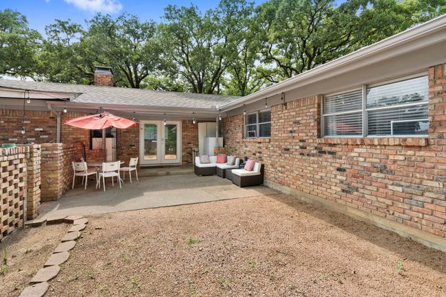 Rear view of property featuring french doors, brick siding, and a patio area | Image 18