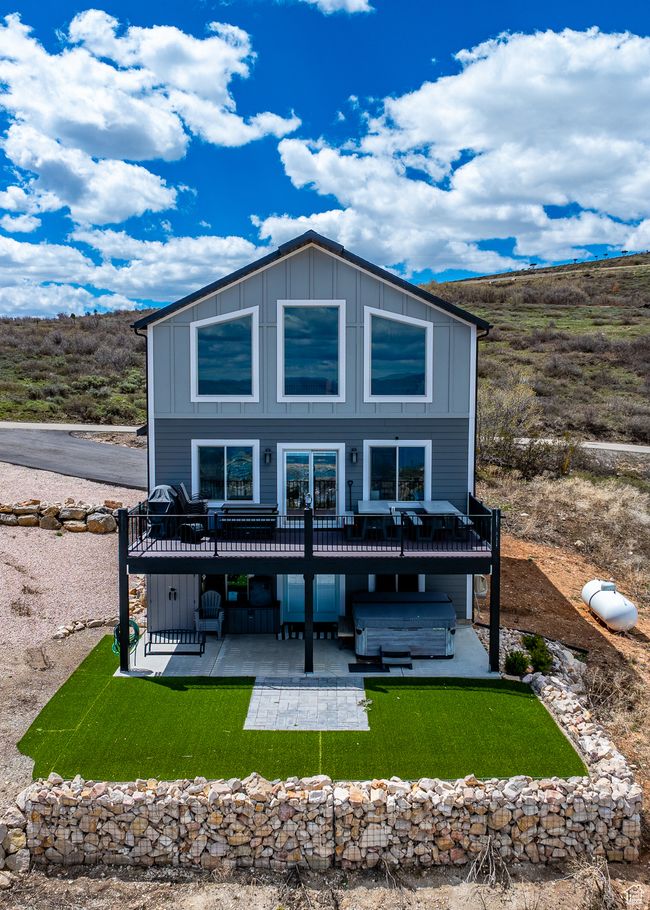 Back of house with board and batten siding, a jacuzzi, a patio area, and a deck | Image 52