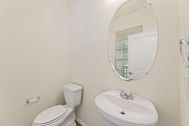 Half bathroom with a sink and toilet | Image 11