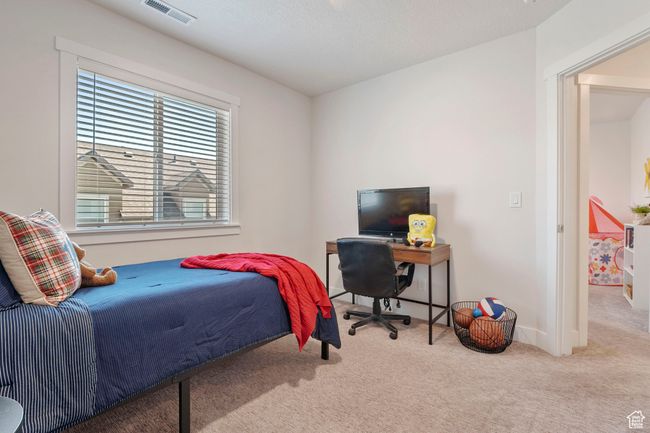 Bedroom with carpet and an office area | Image 20