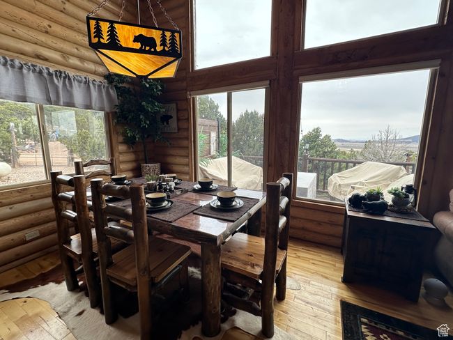 Dining space with log walls and light wood finished floors | Image 7