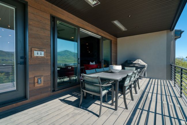 Deck with grilling area and outdoor dining space | Image 12