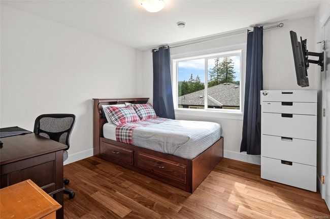Bedroom featuring baseboards and wood finished floors | Image 32