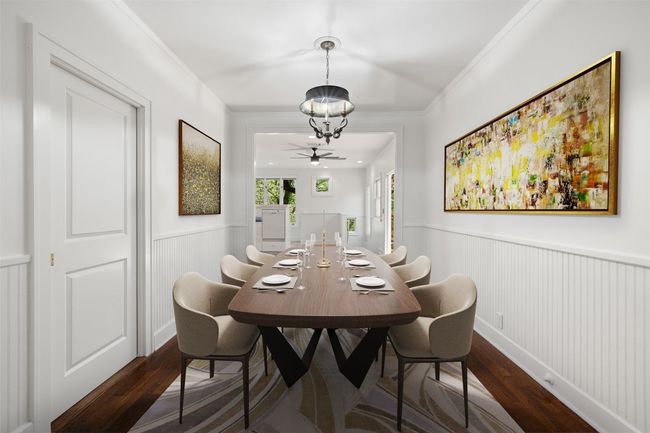 Dining area featuring wainscoting, crown molding, a notable chandelier, and dark wood-type flooring | Image 5