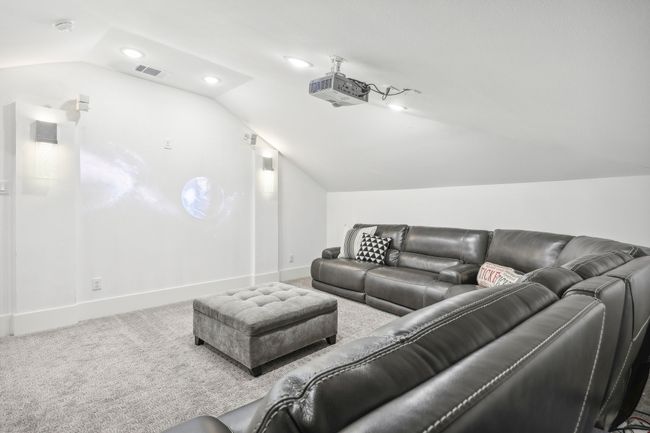 Home theater with lofted ceiling, carpet flooring, and recessed lighting | Image 28
