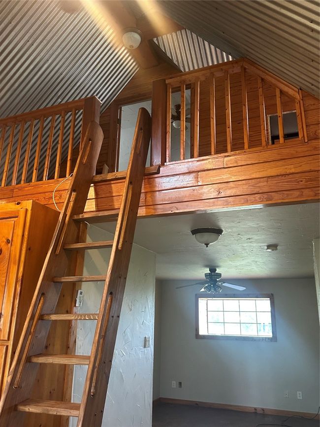 Stairs featuring lofted ceiling and ceiling fan | Image 9