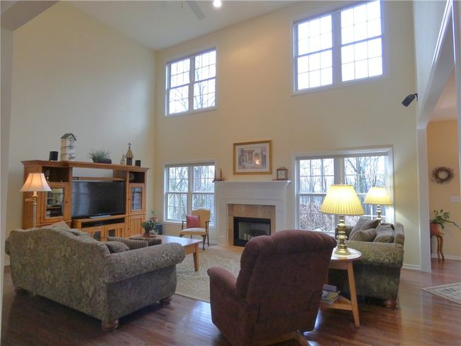 Adjacent to the kitchen is the great room featuring a window wall, vaulted ceiling and a wood burning fireplace that is plumbed for gas | Image 21