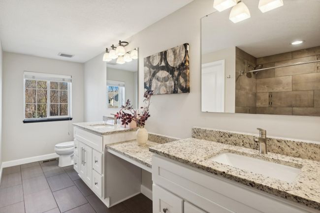 One more view of the private ensuite bathroom. Ample storage, loads of natural light. Can you imagine getting ready for your day in this bathroom? | Image 30