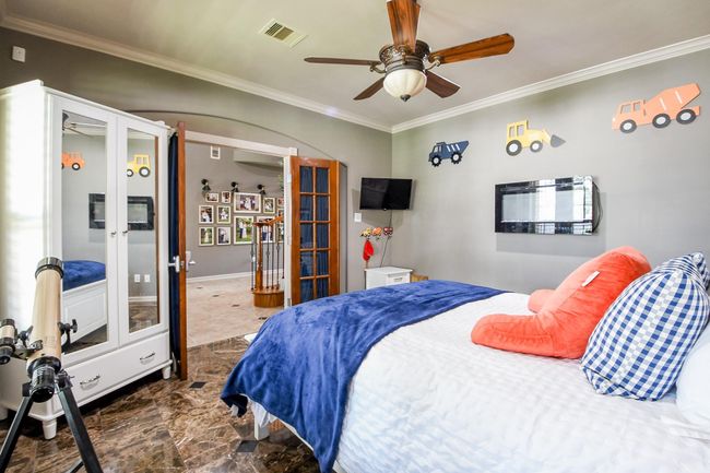 Handsome study with stained french doors and travertine floors. The room is currently used a bedroom | Image 5
