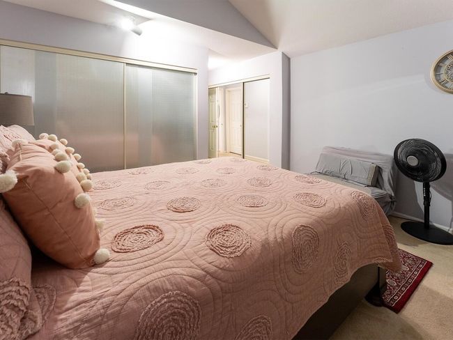 Bedroom with carpet floors and vaulted ceiling | Image 21