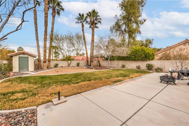 View of extra large yard with a fenced backyard, an outdoor outbuilding, and a patio | Image 4