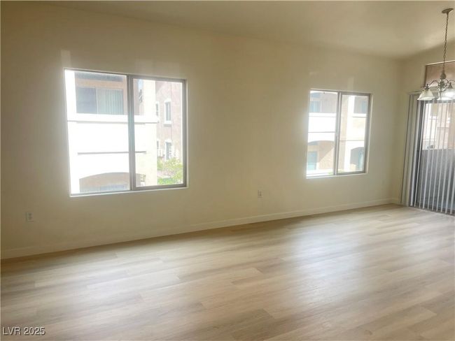 Spare room with a chandelier, healthy amount of natural light, and light wood-style flooring | Image 6
