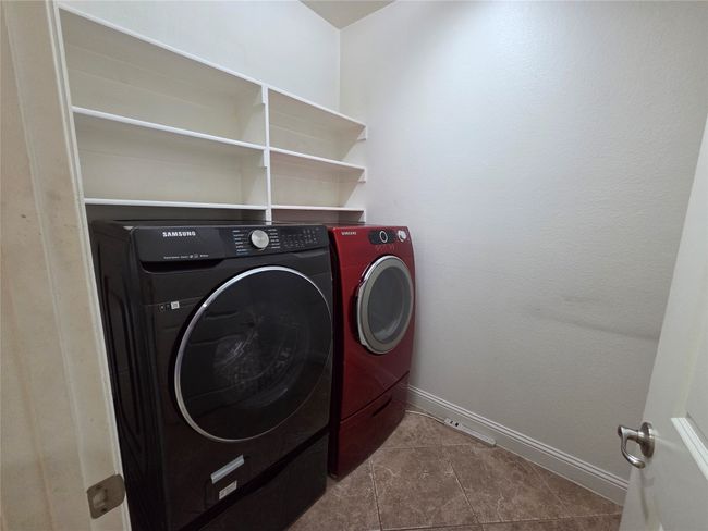 Washroom featuring washer and dryer and tile patterned floors | Image 6
