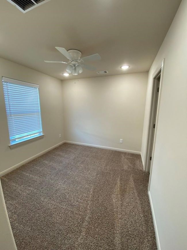 Carpeted empty room with baseboards, ceiling fan, and recessed lighting | Image 8