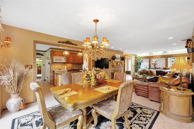 Dining room with light tile patterned floors, a healthy amount of natural light, and recessed lighting | Image 7
