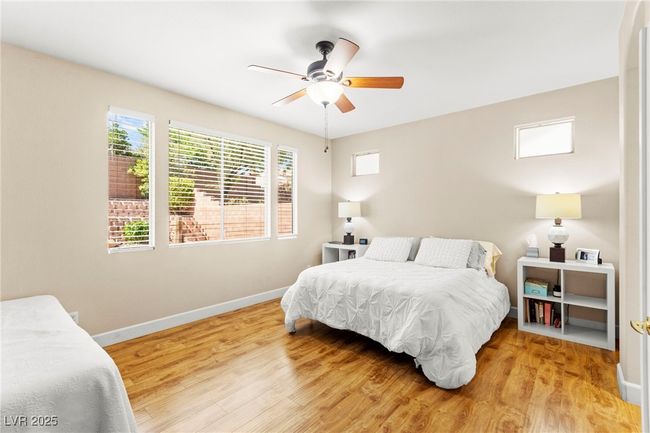 Bedroom featuring baseboards, light wood-style flooring, and ceiling fan | Image 21