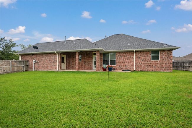 Rear view of property with roof with shingles and brick siding | Image 26