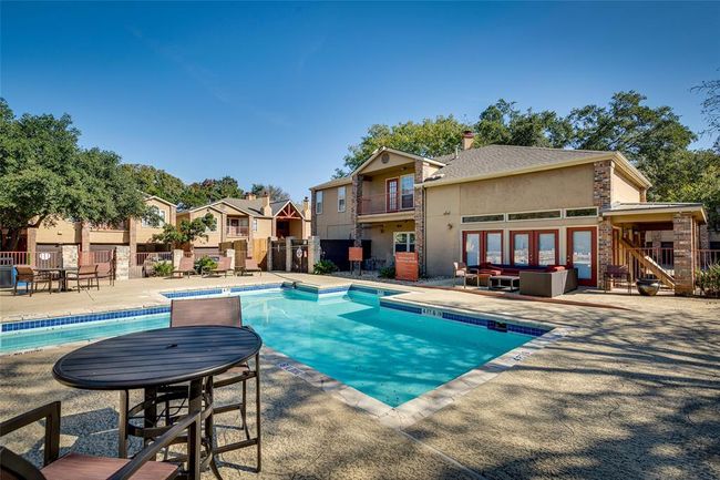 Community pool with a patio and a residential view | Image 12