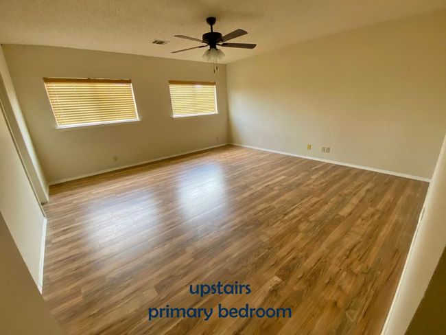 Bedroom with vinyl floors, ceiling fan | Image 17