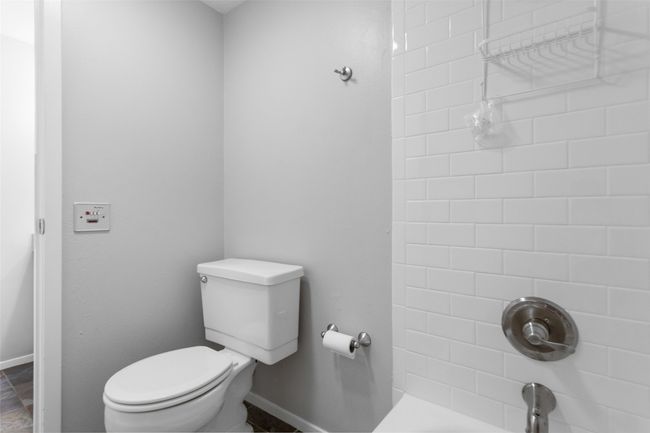 Bathroom with baseboards, toilet, and a shower | Image 25