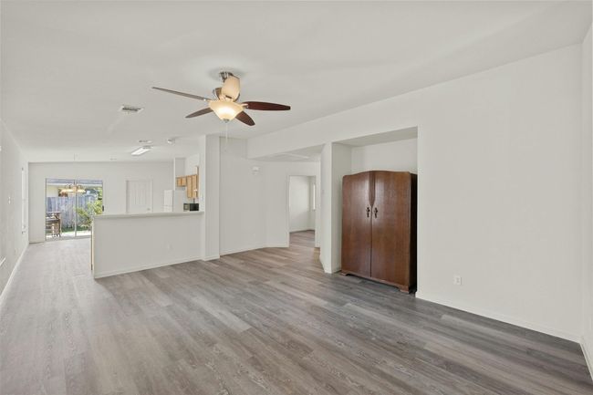 This expansive living room offers plenty of space to accommodate your coziest sectional and favorite furniture pieces, creating a perfect setting for relaxation and gatherings. With ample room to arrange seating and decor, it’s an inviting area for both entertaining and everyday comfort | Image 4