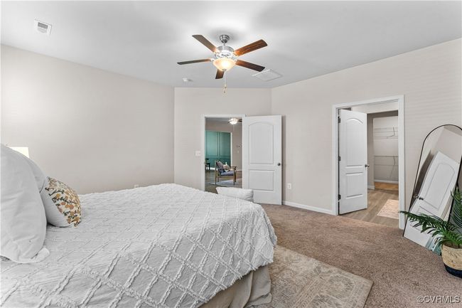 Carpeted bedroom featuring a ceiling fan and baseboards | Image 31