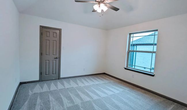 Unfurnished room featuring light colored carpet, baseboards, and a ceiling fan | Image 8