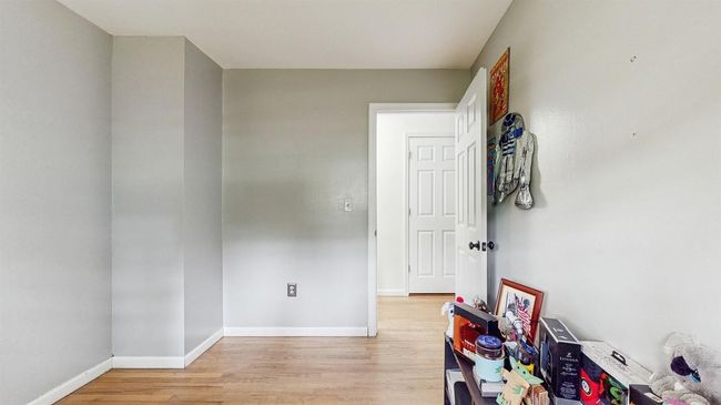 Wonderful Room that's just perfect for a den or person cave! It has light hardwood flooring. | Image 23