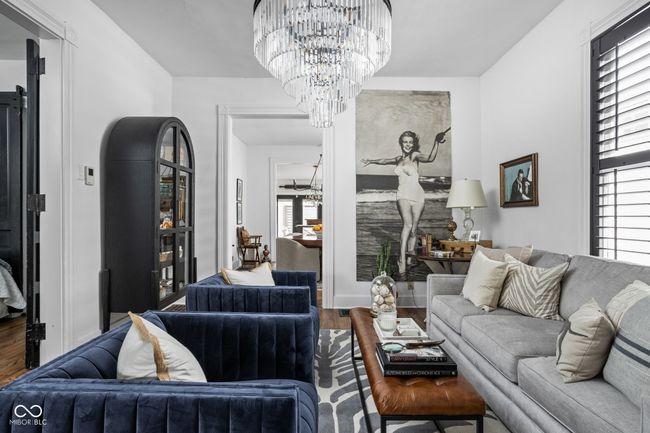Living area with a large chandelier and large original French doors | Image 4