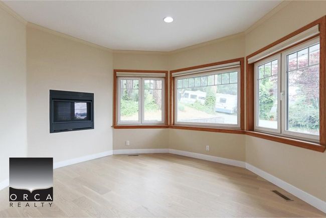 Unfurnished living room featuring plenty of natural light, light wood-style floors, ornamental molding, and recessed lighting | Image 18