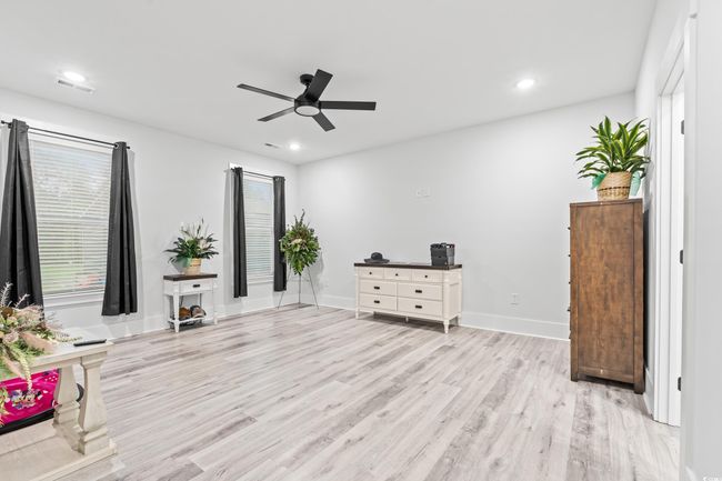 Unfurnished room with a ceiling fan, light wood-style floors, and recessed lighting | Image 9