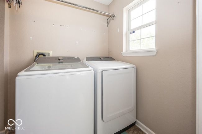 clothes washing area featuring washer and clothes dryer and laundry area | Image 23