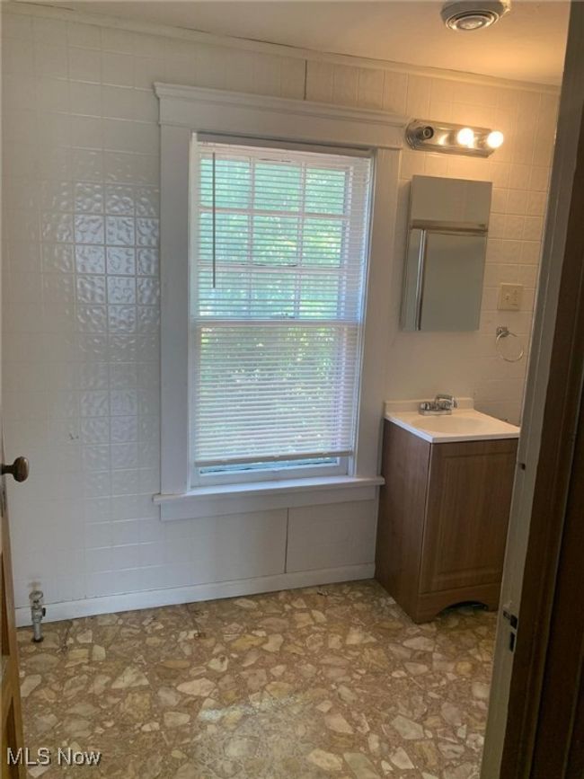 Bathroom with vanity and healthy amount of natural light | Image 4