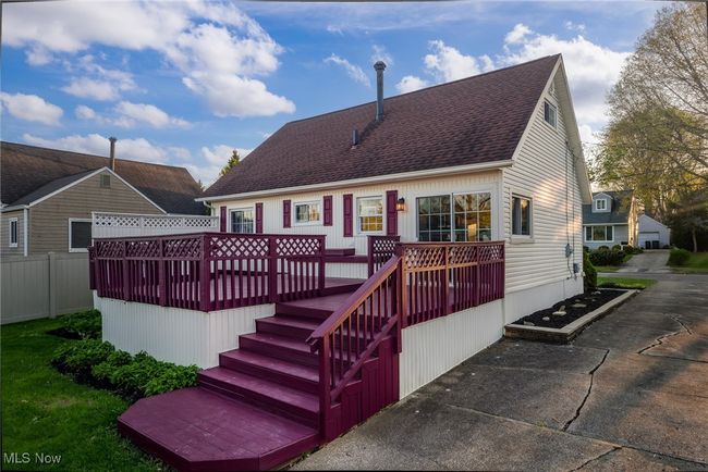 Back of house with fence, a wooden deck, and roof with shingles | Image 5