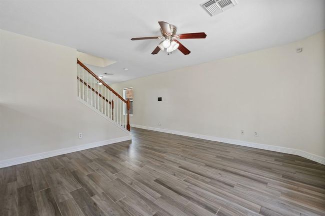 Living area with tile flooring and space to gather or unwind. | Image 8