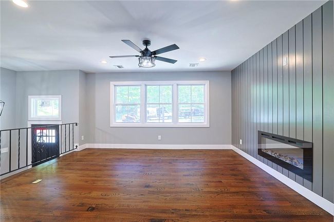 Unfurnished room with hardwood / wood-style floors and ceiling fan | Image 8