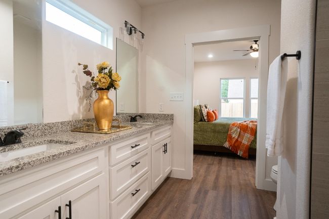 Full bathroom with wood finished floors, double vanity, toilet, a ceiling fan, and connected bathroom | Image 18