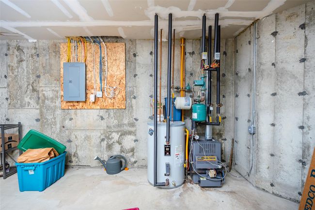 Utilities with electric panel, water heater, and a heating unit | Image 26